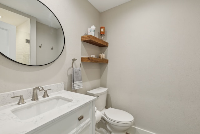 bathroom with toilet and vanity