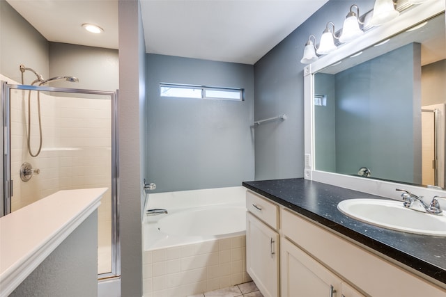 bathroom with vanity, independent shower and bath, and tile patterned flooring