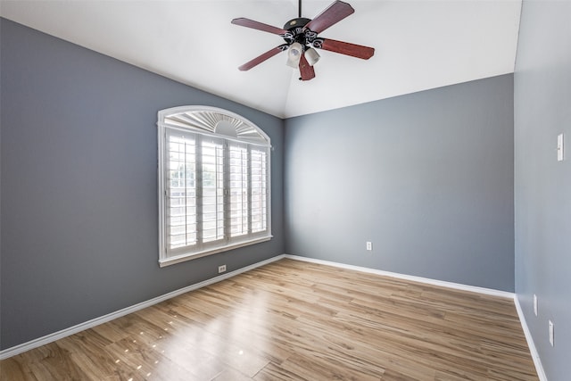 spare room with lofted ceiling, light wood-type flooring, and ceiling fan