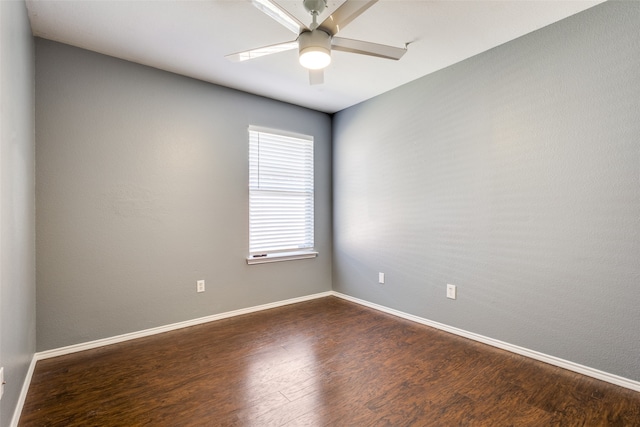 spare room with dark hardwood / wood-style floors and ceiling fan