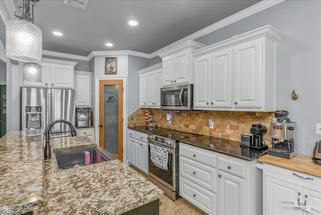 kitchen with white cabinetry, stainless steel appliances, sink, and pendant lighting