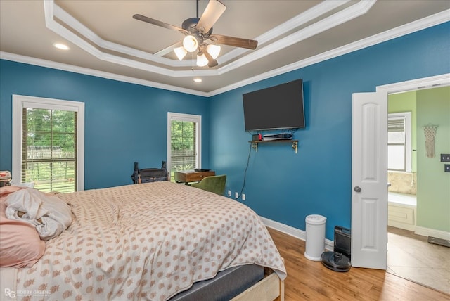 bedroom with multiple windows, hardwood / wood-style flooring, crown molding, and ceiling fan