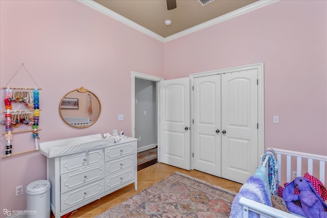 bedroom featuring a closet, crown molding, light parquet flooring, and ceiling fan