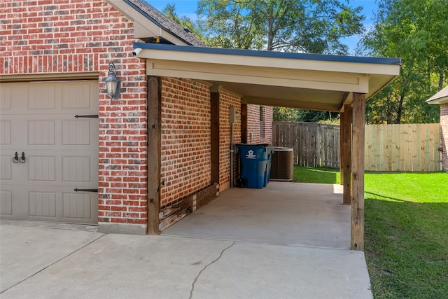 exterior space featuring a garage, central air condition unit, and a carport