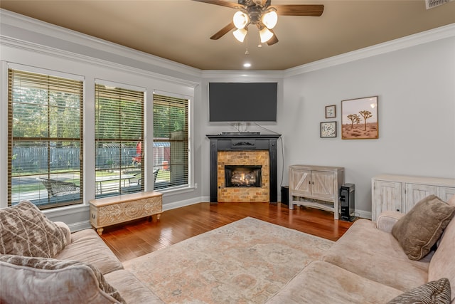 living room with crown molding, ceiling fan, wood-type flooring, and a wealth of natural light