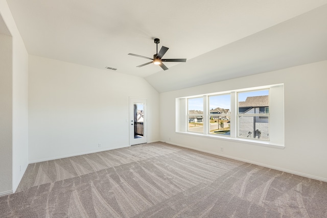 carpeted spare room with lofted ceiling and ceiling fan