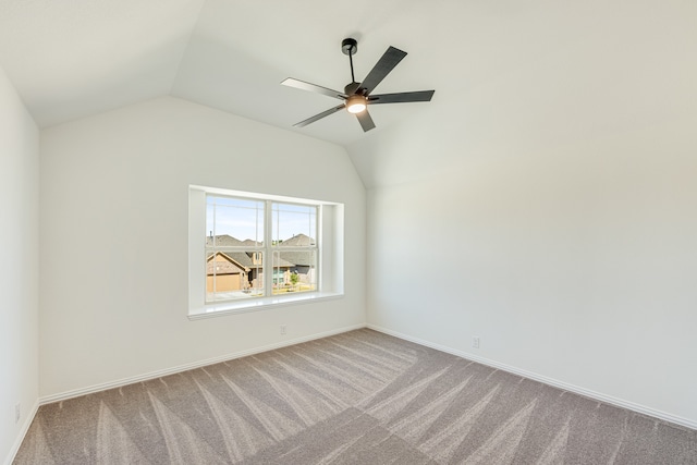 carpeted empty room with lofted ceiling and ceiling fan