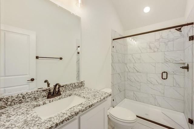 bathroom with a shower with door, lofted ceiling, vanity, and toilet