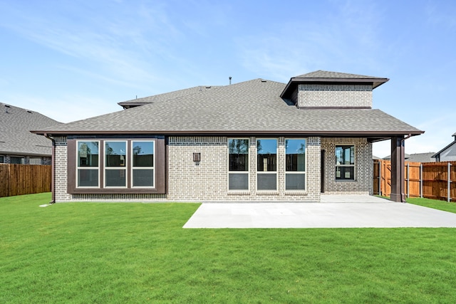 rear view of house with a patio area and a lawn