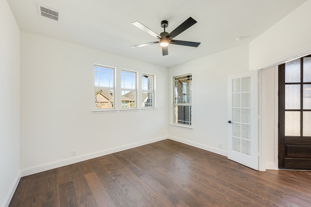 empty room featuring french doors, dark hardwood / wood-style floors, and ceiling fan