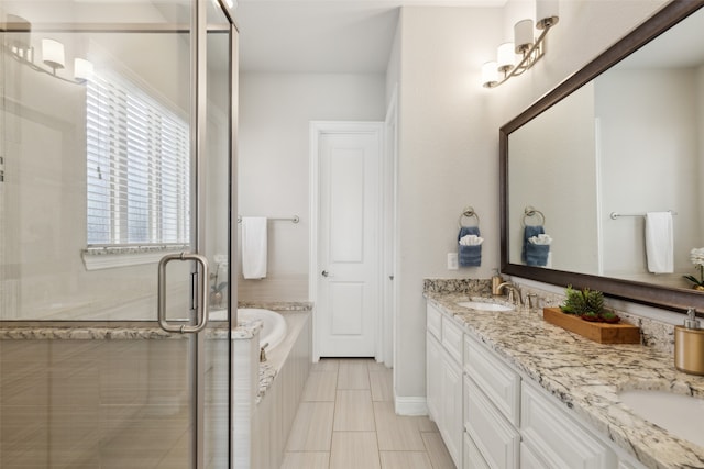 bathroom with vanity and independent shower and bath