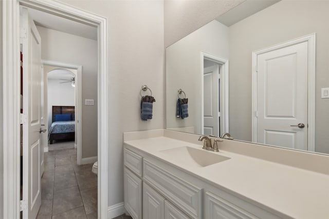 bathroom featuring vanity, toilet, tile patterned floors, and ceiling fan