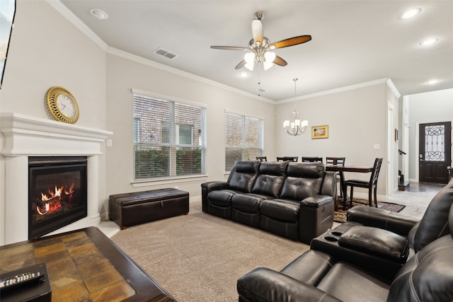 living room featuring light carpet, ornamental molding, and ceiling fan with notable chandelier