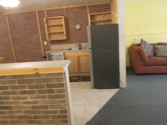 kitchen with sink, appliances with stainless steel finishes, and light tile patterned floors