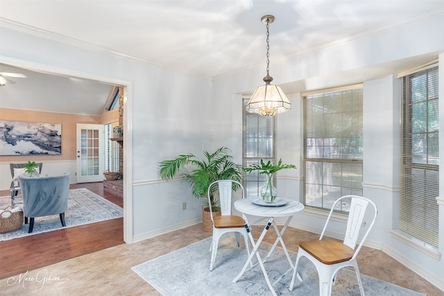 dining space with crown molding, light hardwood / wood-style flooring, and a notable chandelier