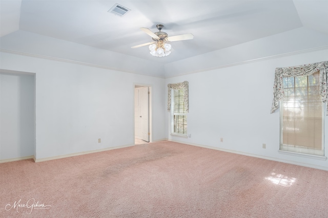 spare room featuring light carpet, vaulted ceiling, and ceiling fan