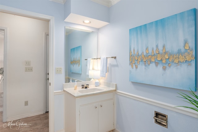 bathroom with vanity, crown molding, and tile patterned flooring