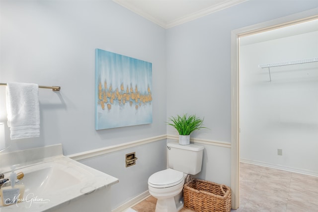 bathroom with toilet, crown molding, sink, and tile patterned floors