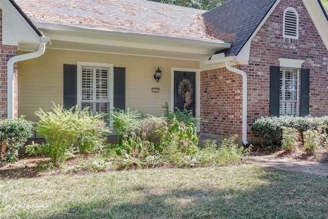 doorway to property with a yard