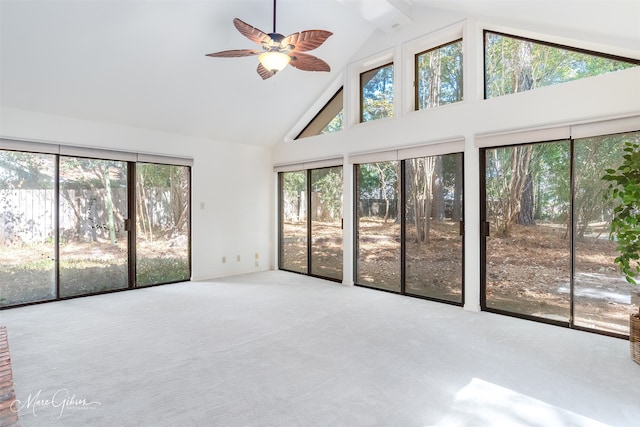 unfurnished sunroom with ceiling fan, vaulted ceiling, and plenty of natural light