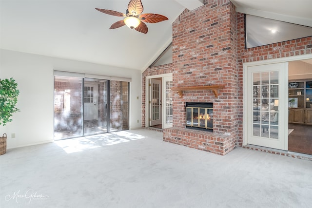 unfurnished living room featuring a fireplace, carpet floors, a healthy amount of sunlight, and ceiling fan