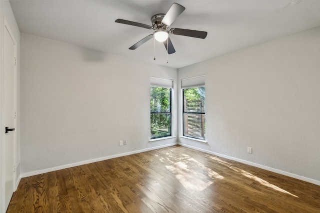 unfurnished room with a ceiling fan, baseboards, and wood finished floors