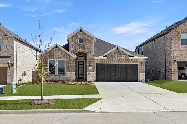 view of front of home with a garage and a front lawn