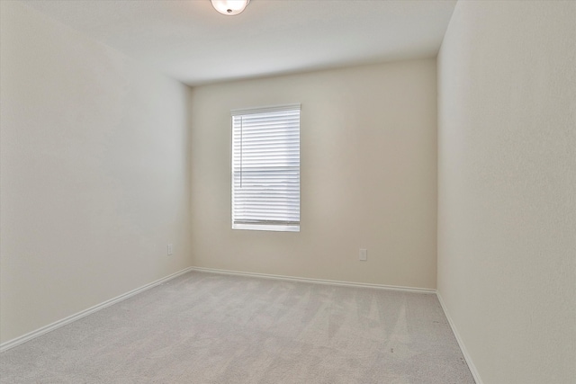 unfurnished room with light colored carpet