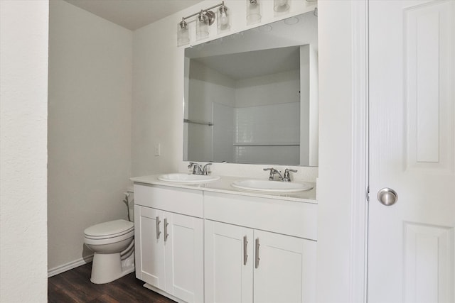 bathroom featuring vanity, toilet, and wood-type flooring