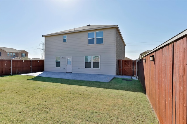 back of house featuring a patio and a lawn