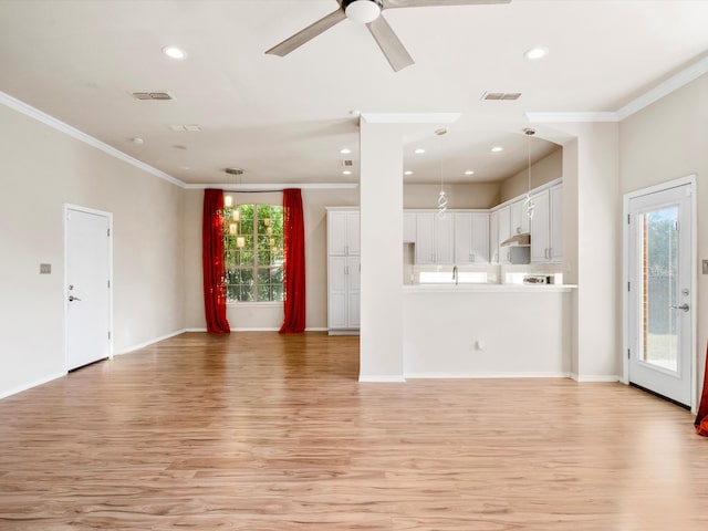 unfurnished living room with light hardwood / wood-style floors, ceiling fan, ornamental molding, and sink