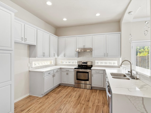 kitchen with sink, white cabinets, and appliances with stainless steel finishes