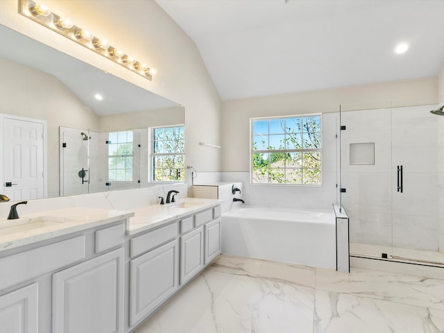 bathroom with vanity, separate shower and tub, and vaulted ceiling