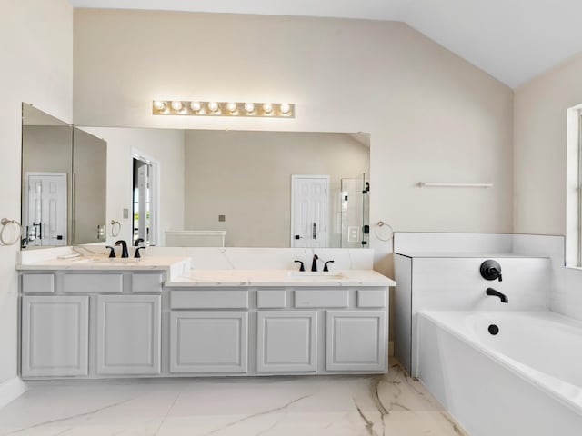 bathroom with vanity, lofted ceiling, and independent shower and bath