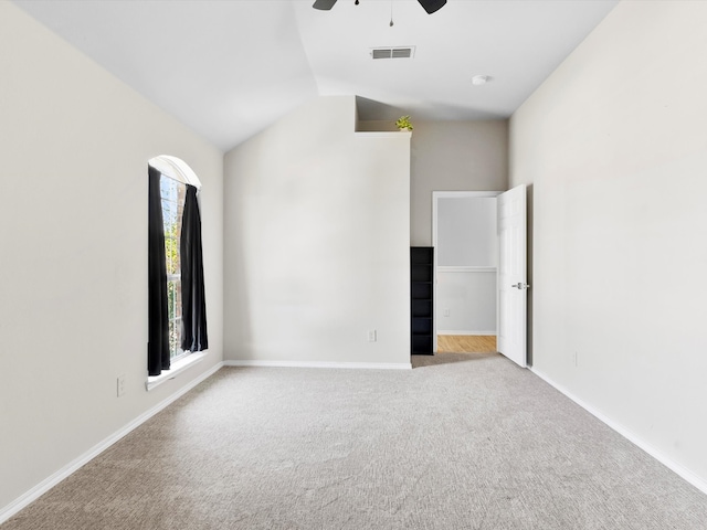 unfurnished bedroom featuring ceiling fan, light colored carpet, and vaulted ceiling