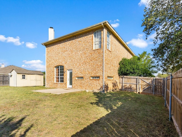 back of property featuring a patio, a shed, and a lawn