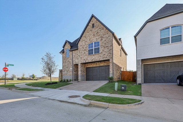 view of front of property featuring a garage and a front lawn