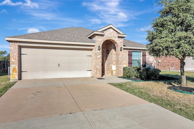 ranch-style home featuring a front yard and a garage