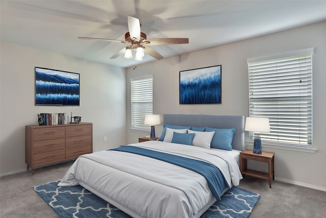 bedroom featuring light carpet and ceiling fan