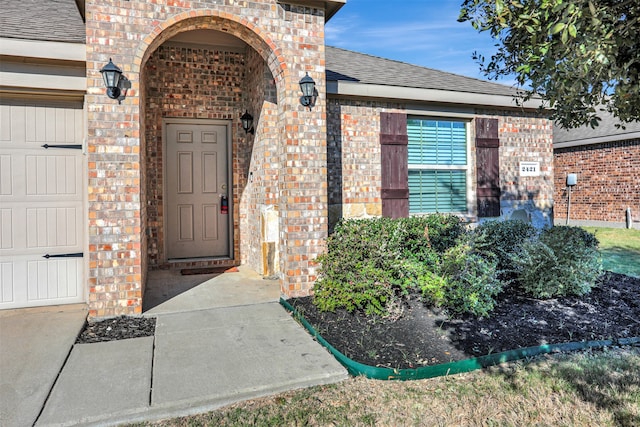 view of exterior entry featuring a garage