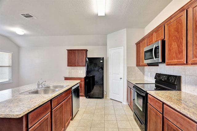 kitchen featuring black appliances, light tile patterned flooring, sink, backsplash, and a center island with sink