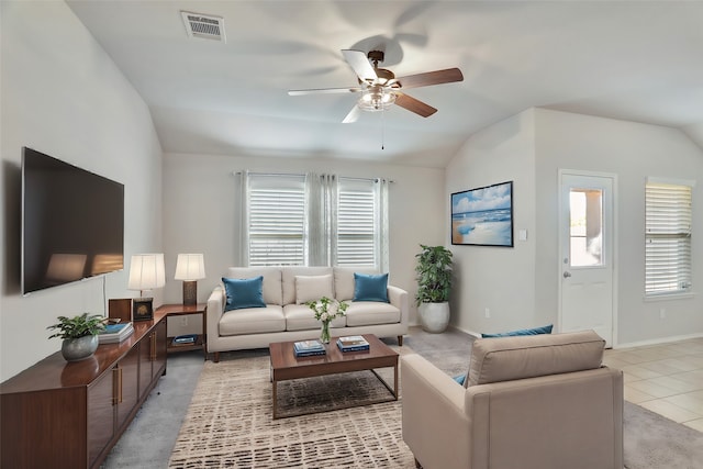 living room featuring ceiling fan, light tile patterned flooring, and lofted ceiling