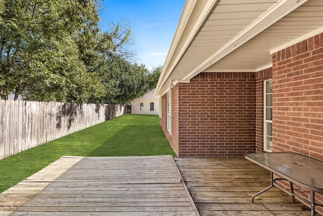 wooden terrace featuring a lawn