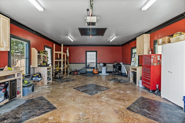 garage with a garage door opener, a workshop area, and cooling unit