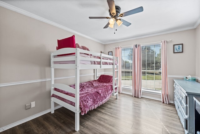 bedroom featuring ceiling fan, wood-type flooring, and ornamental molding