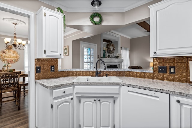 kitchen with white cabinets, dark hardwood / wood-style flooring, backsplash, white dishwasher, and sink