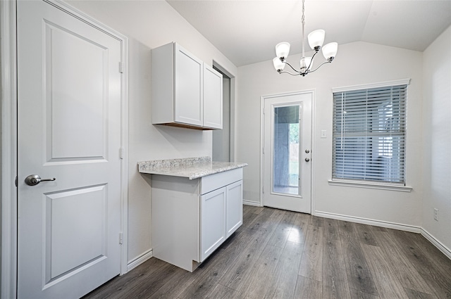 doorway to outside with an inviting chandelier, lofted ceiling, and dark hardwood / wood-style flooring