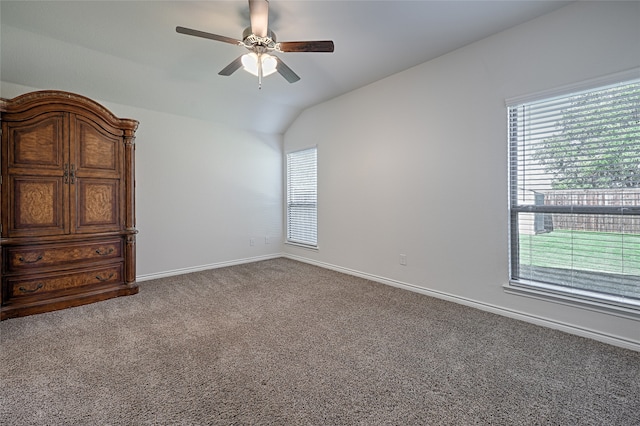 carpeted empty room featuring ceiling fan and vaulted ceiling