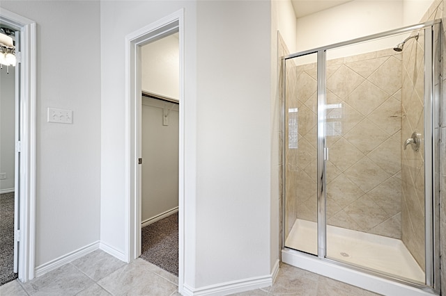 bathroom featuring a shower with door and tile patterned flooring