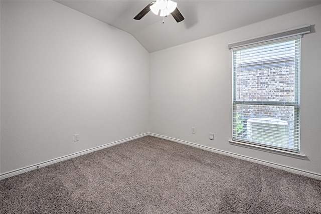 empty room with lofted ceiling, carpet flooring, and ceiling fan